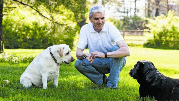 Oliver Amice, CEO of Whitebridge Pet Brands and his two dogs.